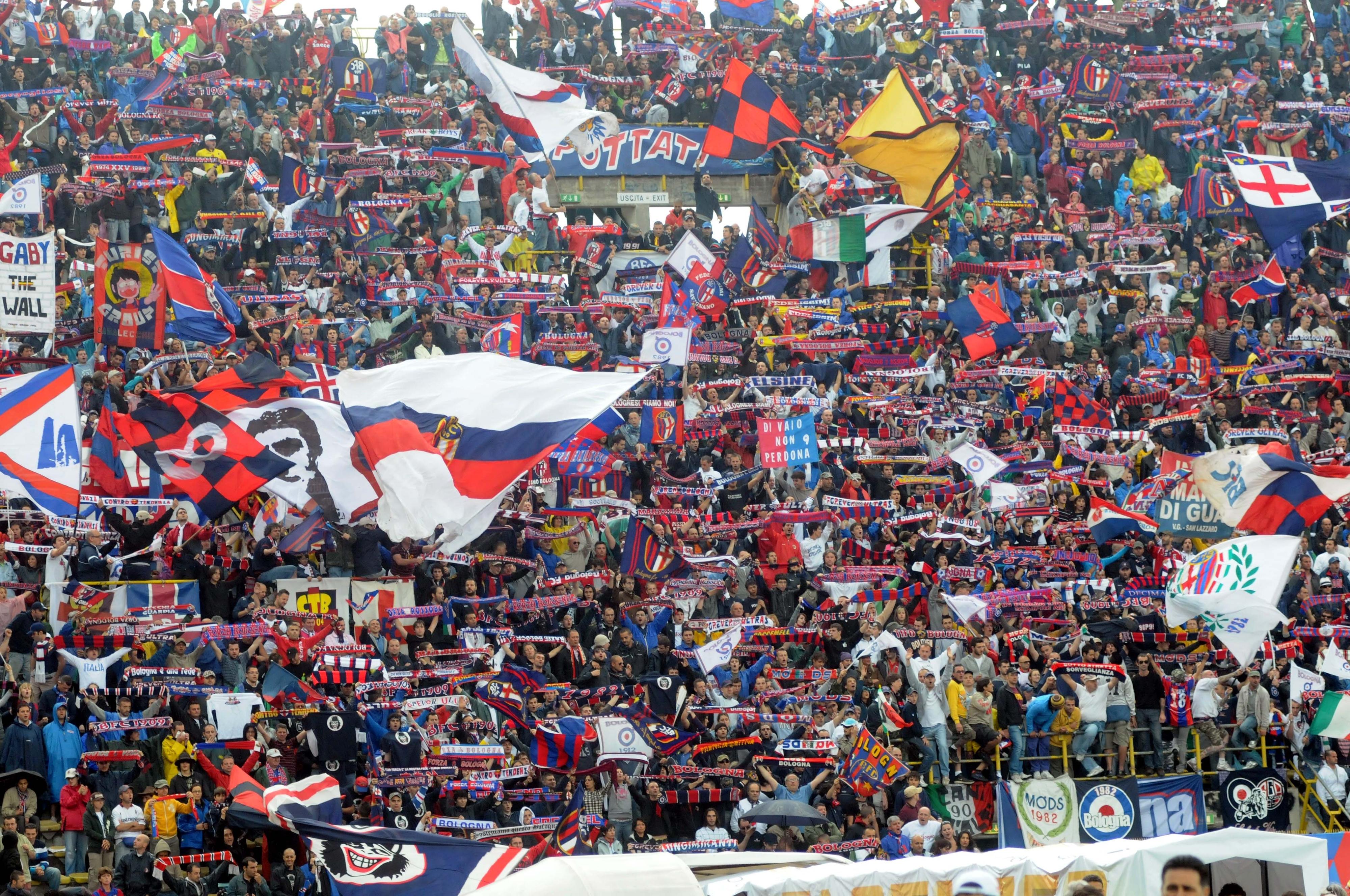 https://sport.quotidiano.net/image-service/view/acePublic/alias/contentid/MGFiMzk0MDktNDMxMS00/2/bandiere-e-tifo-nella-curva-rossoblu.jpeg